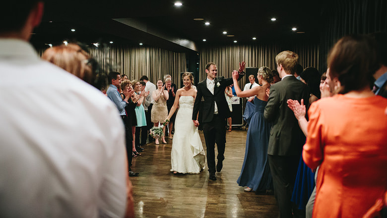bride and groom exit reception waving goodbye